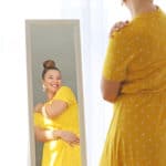 woman admires her body in mirror
